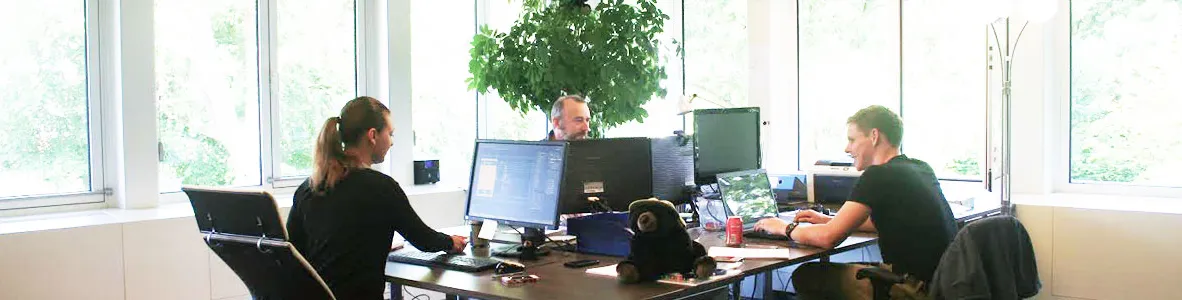 Cross-functional engineering team collaborating in a workshop